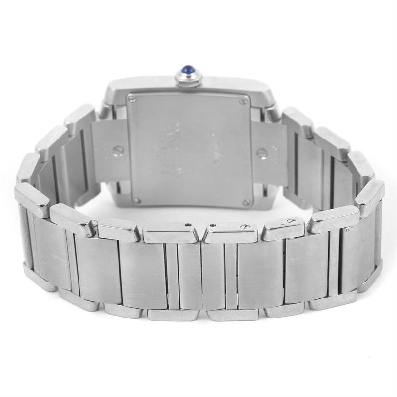 The image shows the back view of a Cartier Tank Française watch, highlighting its stainless steel case and bracelet.