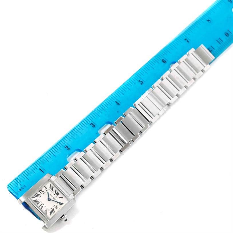 The image shows the Tank Francaise model by Cartier from a top-down angle, displaying the watch face, bracelet, and a ruler next to it for scale.