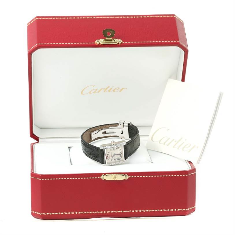 The watch is a Cartier Tank Francaise WE100231 Women's White Gold Silver Dial WE100231 Women's White Gold Silver Dial model, shown inside an open red Cartier box with an instruction booklet beside it.