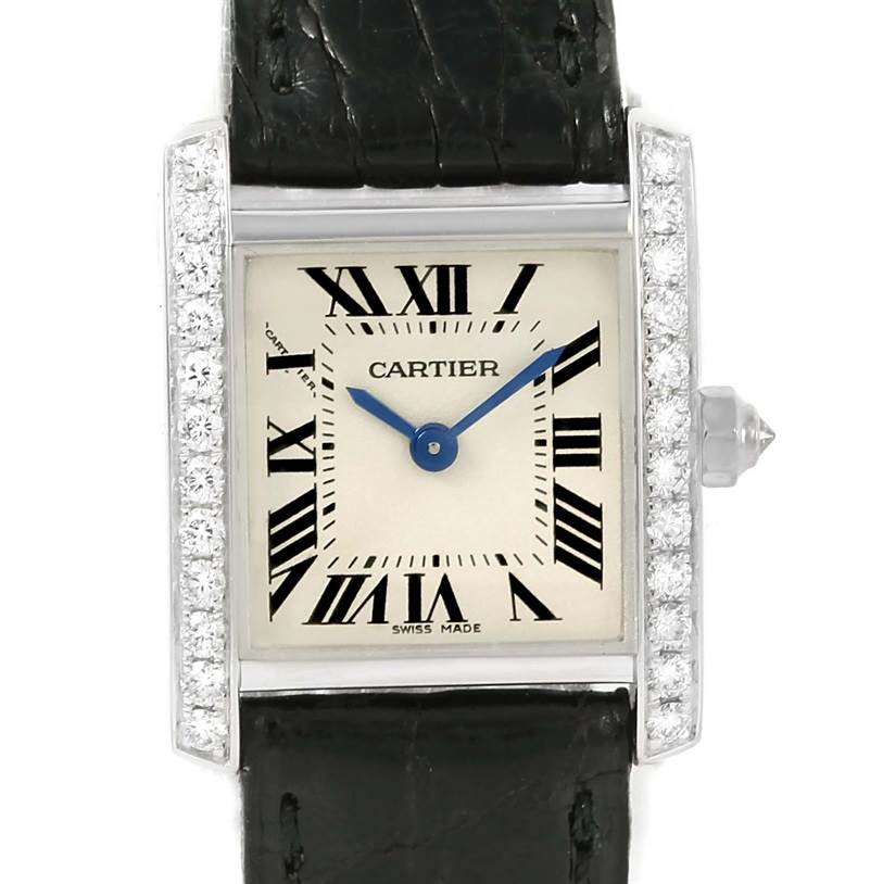 The image shows a close-up of a Cartier Tank Francaise WE100231 Women's White Gold Silver Dial WE100231 Women's White Gold Silver Dial watch face with a diamond-studded bezel and black leather strap.
