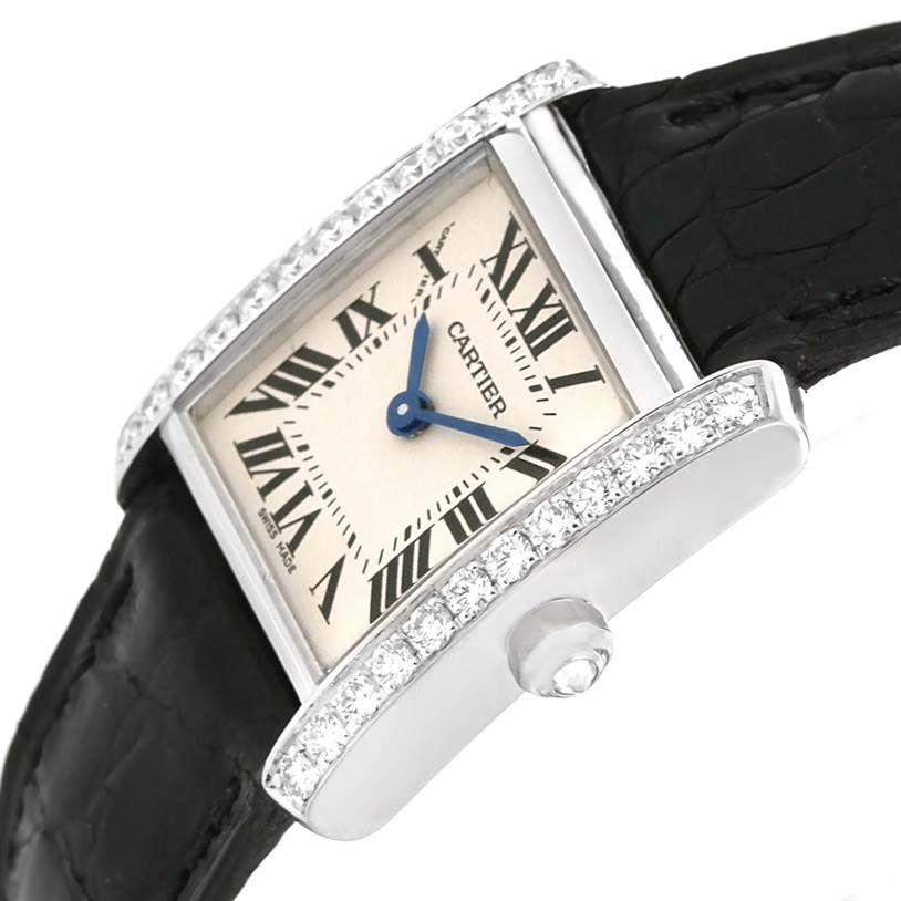 The image shows a Cartier Tank Francaise WE100231 Women's White Gold Silver Dial WE100231 Women's White Gold Silver Dial watch angled to highlight its face, diamond-studded bezel, and black leather strap.