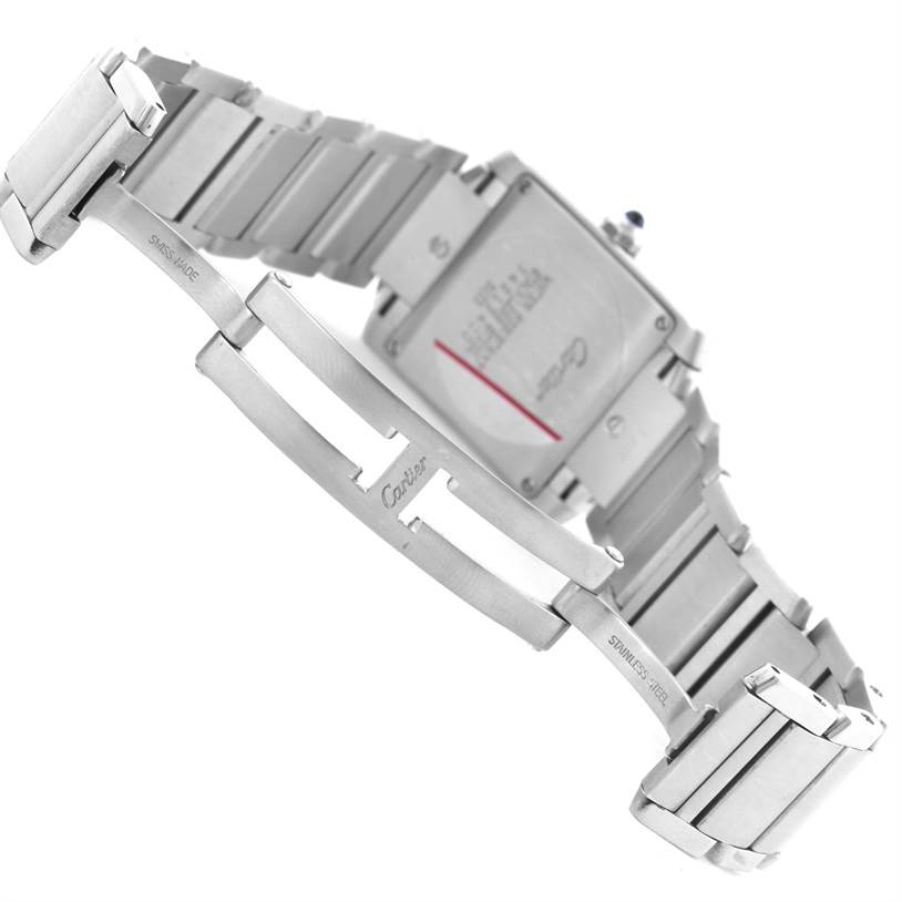 This image shows the underside of a Cartier Tank Française watch, highlighting the stainless steel bracelet and clasp, along with the watch's case back.