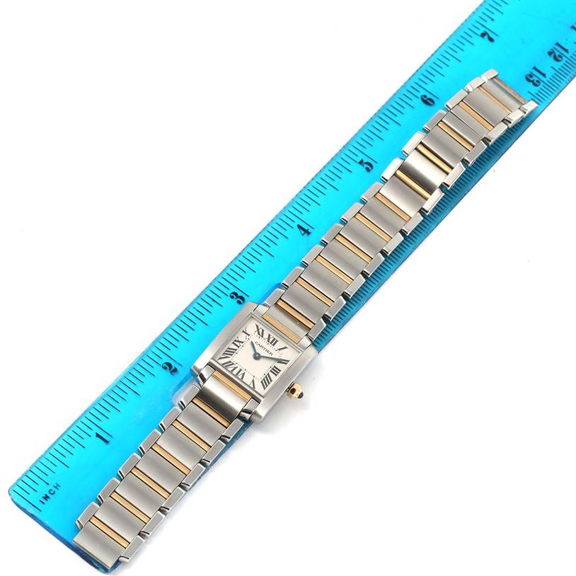 The Cartier Tank Francaise W51007Q4 Women's Steel and Gold (two tone) Silver Dial W51007Q4 Women's Steel and Gold (two tone) Silver Dial watch is shown from above, featuring the rectangular case, face, and bracelet along a blue ruler.