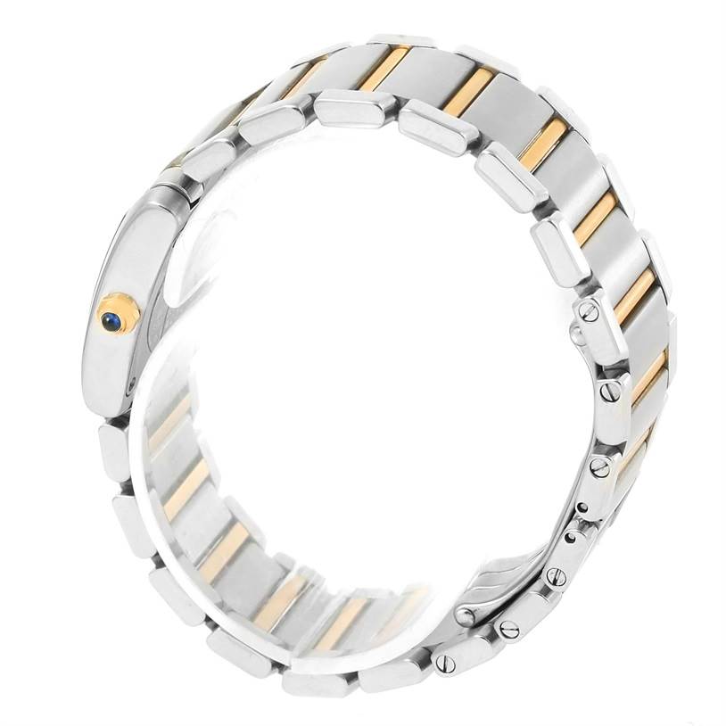 This image features a close-up of the Cartier Tank Francaise W51007Q4 Women's Steel and Gold (two tone) Silver Dial W51007Q4 Women's Steel and Gold (two tone) Silver Dial watch bracelet from a side angle, highlighting the metal links and screw details.