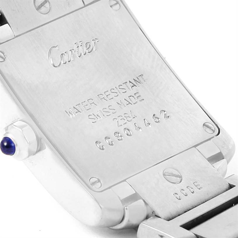 The image shows the back case and part of the bracelet of the Cartier Tank Francaise W51008Q3 Women's Stainless Steel Silver Dial W51008Q3 Women's Stainless Steel Silver Dial watch, displaying inscriptions and the brand logo.