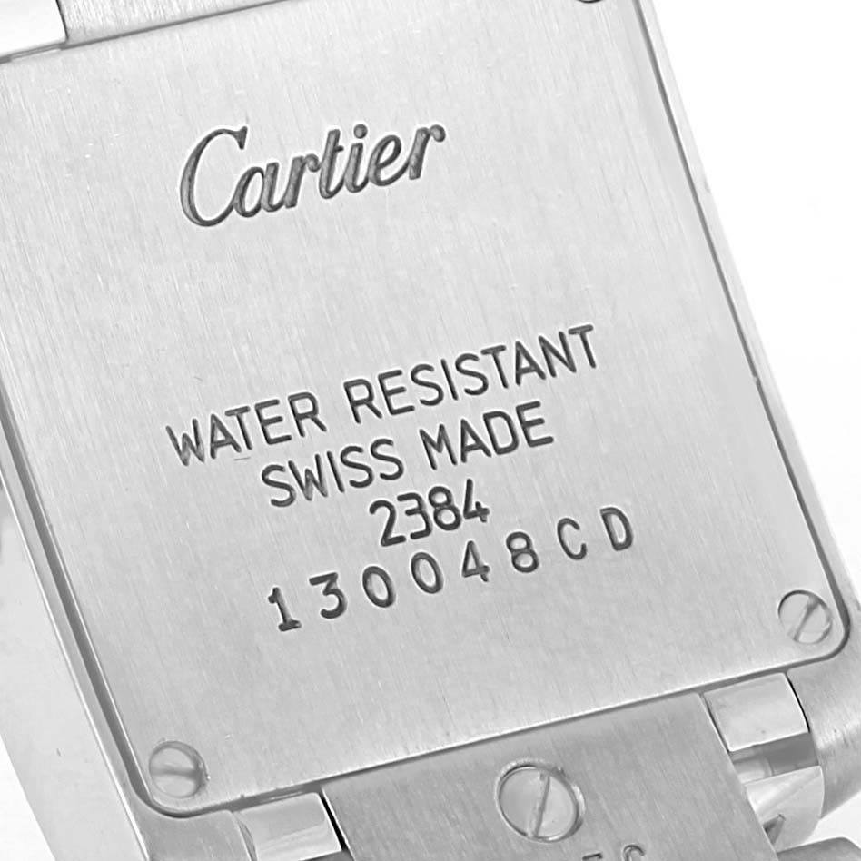 This image shows the back casing of a Cartier Tank Française watch, highlighting details like water resistance and serial numbers.