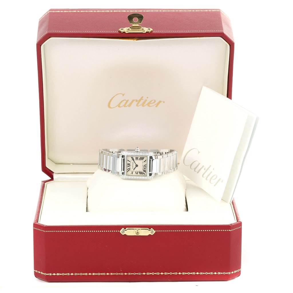 The Cartier Tank Francaise WE1002S3 Women's White Gold Silver Dial WE1002S3 Women's White Gold Silver Dial watch is displayed frontally in an open Cartier box with associated documents.