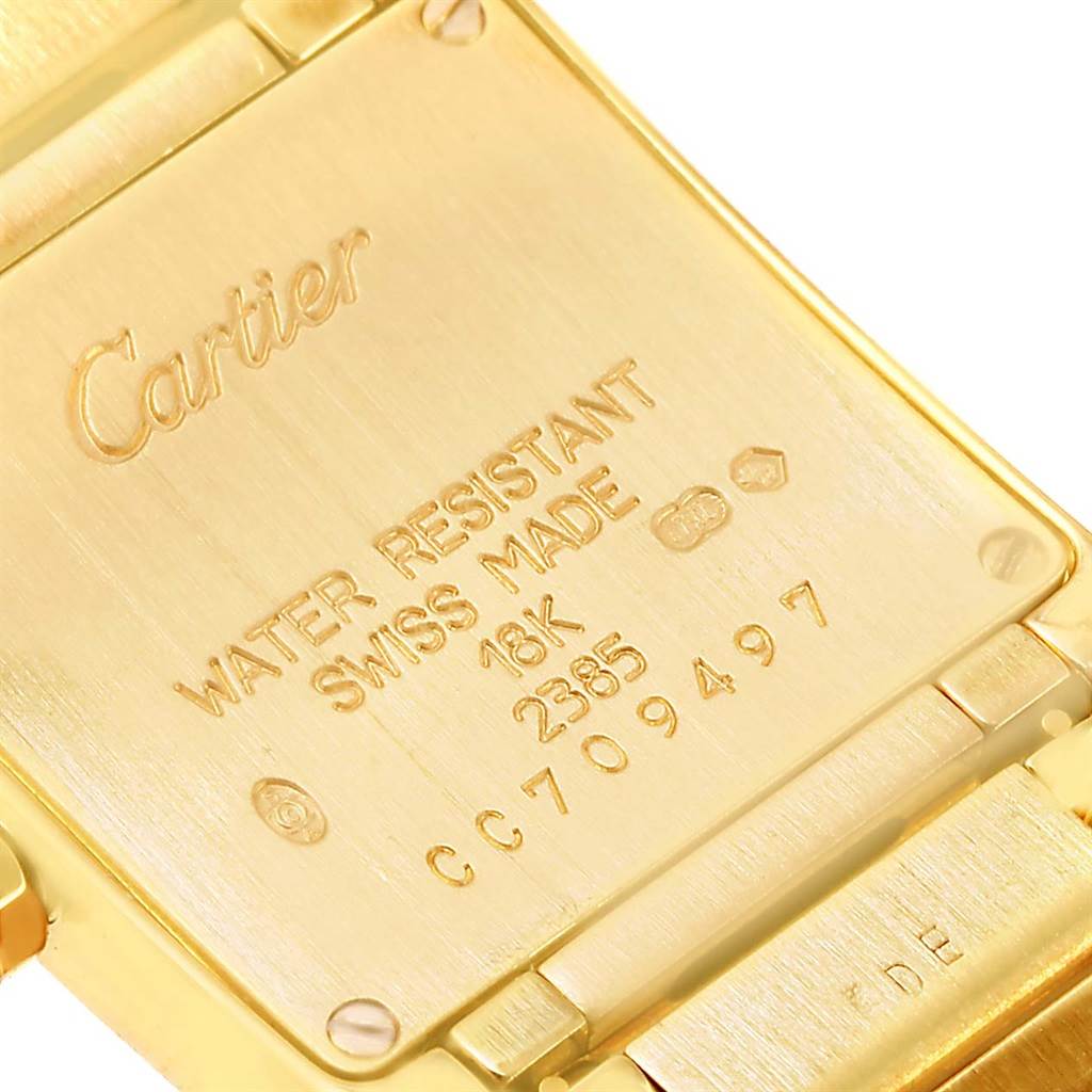 The image shows the back case of a Cartier Tank Française watch, highlighting inscriptions including the brand name, water resistance, and material details.