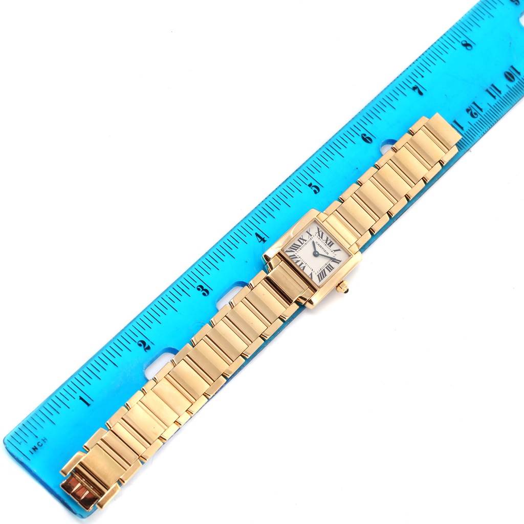 The Cartier Tank Francaise W50002N2 Women's Yellow Gold Silver Dial W50002N2 Women's Yellow Gold Silver Dial watch is shown from an overhead angle, lying flat against a ruler.