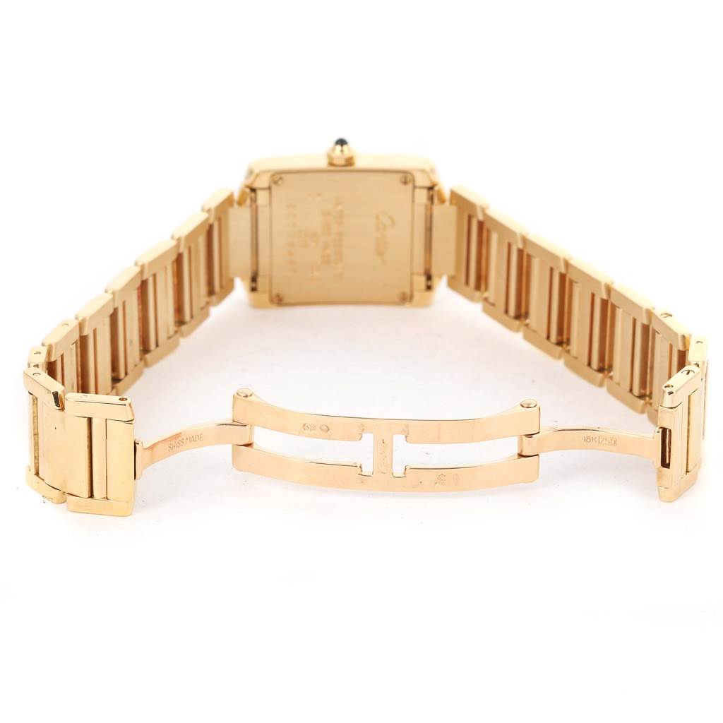 The image shows the back view of a Cartier Tank Française watch, focusing on its gold bracelet and clasp.