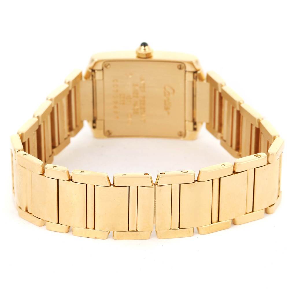 The image shows a rear view of the Cartier Tank Francaise W50002N2 Women's Yellow Gold Silver Dial W50002N2 Women's Yellow Gold Silver Dial watch, highlighting its gold bracelet and case back.