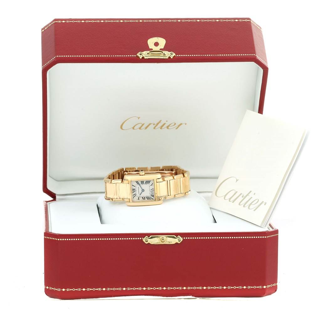 The Cartier Tank Francaise W50002N2 Women's Yellow Gold Silver Dial W50002N2 Women's Yellow Gold Silver Dial watch is displayed at a frontal angle inside its open red box, with a booklet by its side.