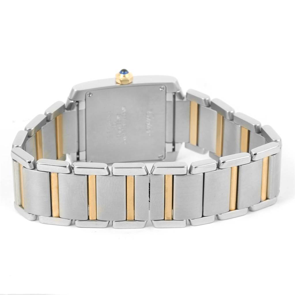 The image shows the case back and bracelet of a Cartier Tank Francaise W2TA0003 Women's Steel and Gold (two tone) Silver Dial W2TA0003 Women's Steel and Gold (two tone) Silver Dial watch, highlighting its two-tone metal design.