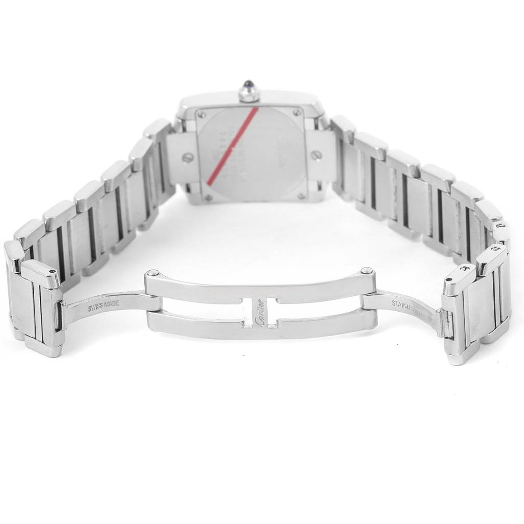 The image shows the back case and open clasp of a Cartier Tank Française watch, highlighting its stainless steel bracelet.