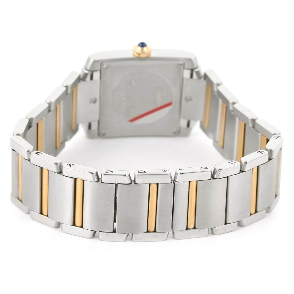 This image shows the back and bracelet of a Cartier Tank Française watch, highlighting its metal links with gold accents.