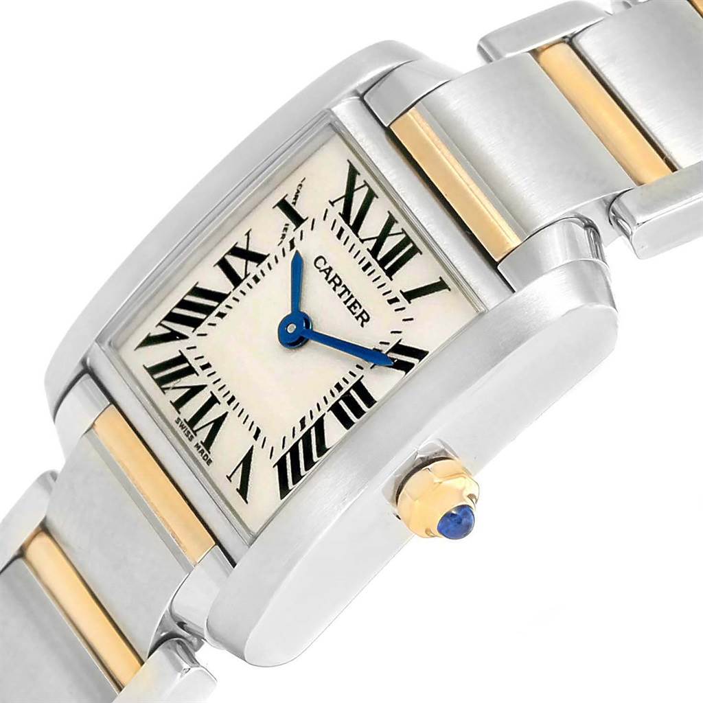 The image shows a close-up angled view of a Cartier Tank Française watch, highlighting the dial, crown, and part of the metal bracelet.