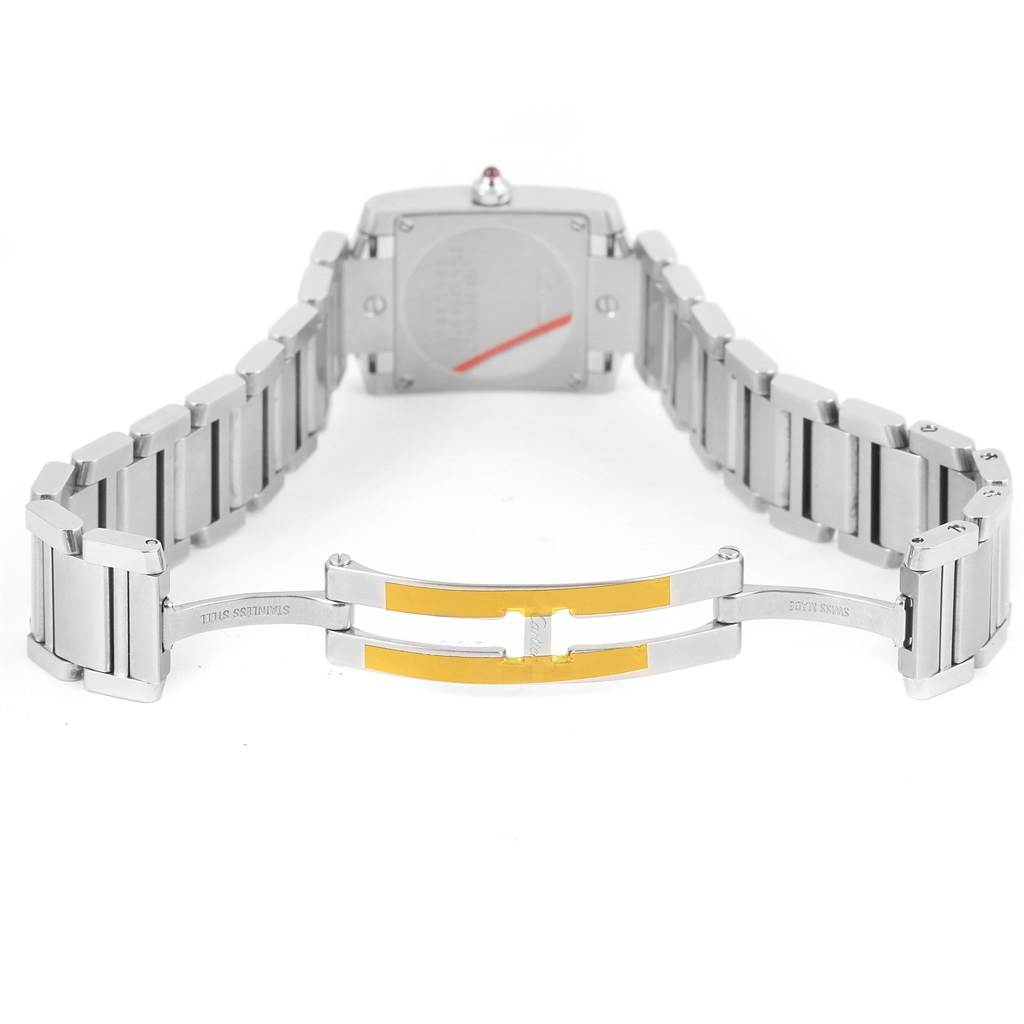 The image shows the back of a Cartier Tank Française watch, highlighting its stainless steel bracelet and clasp mechanism.
