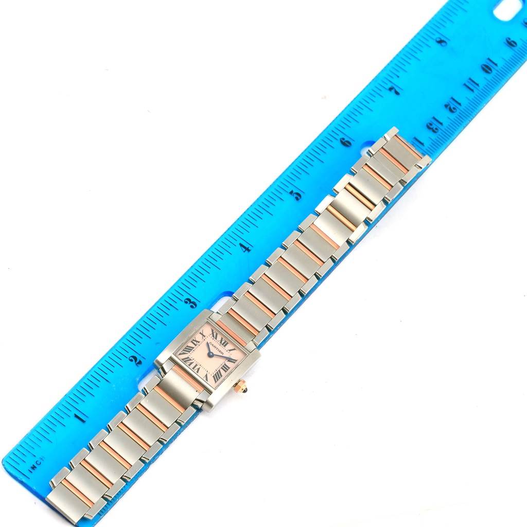 The Cartier Tank Francaise W51027Q4 Women's Steel and Gold (two tone) Mother of Pearl Dial W51027Q4 Women's Steel and Gold (two tone) Mother of Pearl Dial watch is shown flat with its full bracelet and face visible alongside a blue ruler.