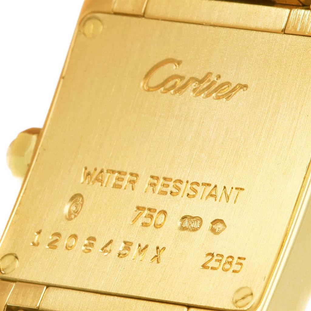 The image shows the back case of a Tank Francaise model by Cartier, highlighting the engravings and material details.