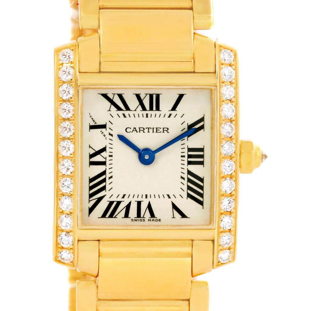 Close-up angle of the Cartier Tank Francaise WE1001R8 Women's Yellow Gold Silver Dial WE1001R8 Women's Yellow Gold Silver Dial watch showing the face, Roman numerals, blue hands, diamond bezel, and part of the gold bracelet.