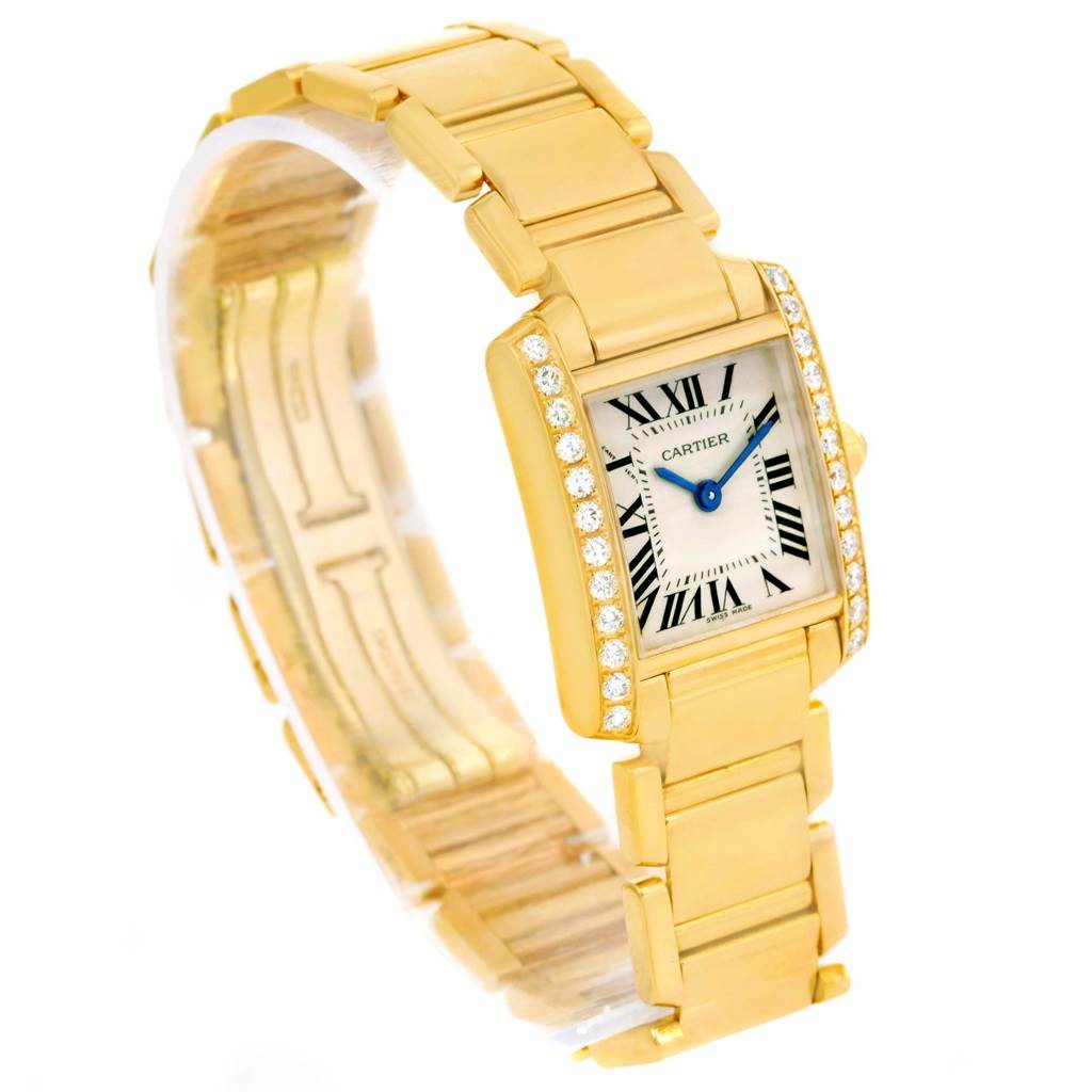 This image shows a gold Cartier Tank Francaise WE1001R8 Women's Yellow Gold Silver Dial WE1001R8 Women's Yellow Gold Silver Dial watch at an angled view, highlighting the bracelet, diamond bezel, and Roman numeral dial.