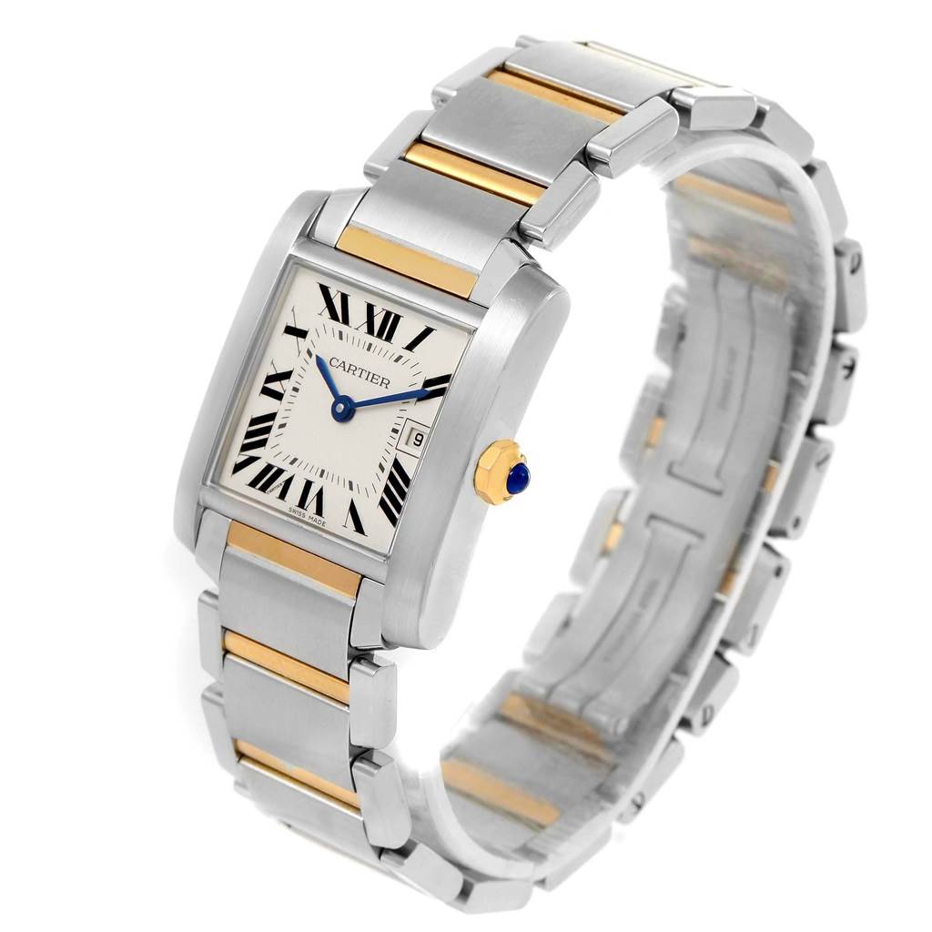 The image shows a Cartier Tank Française watch at an oblique angle, highlighting its dial, crown, and two-tone metal bracelet.