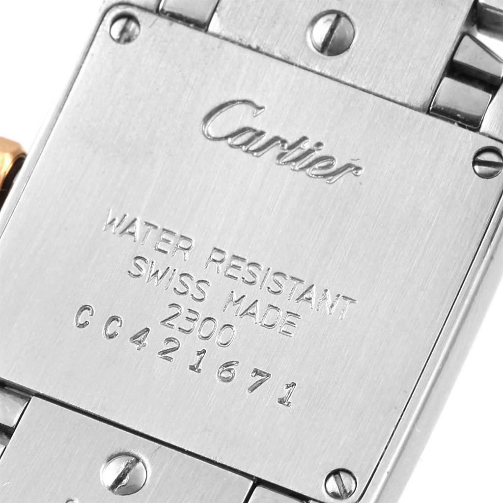 This image shows the back case of a Cartier Tank Francaise W51007Q4 Women's Steel and Gold (two tone) Silver Dial W51007Q4 Women's Steel and Gold (two tone) Silver Dial watch, highlighting its engravings and screws.