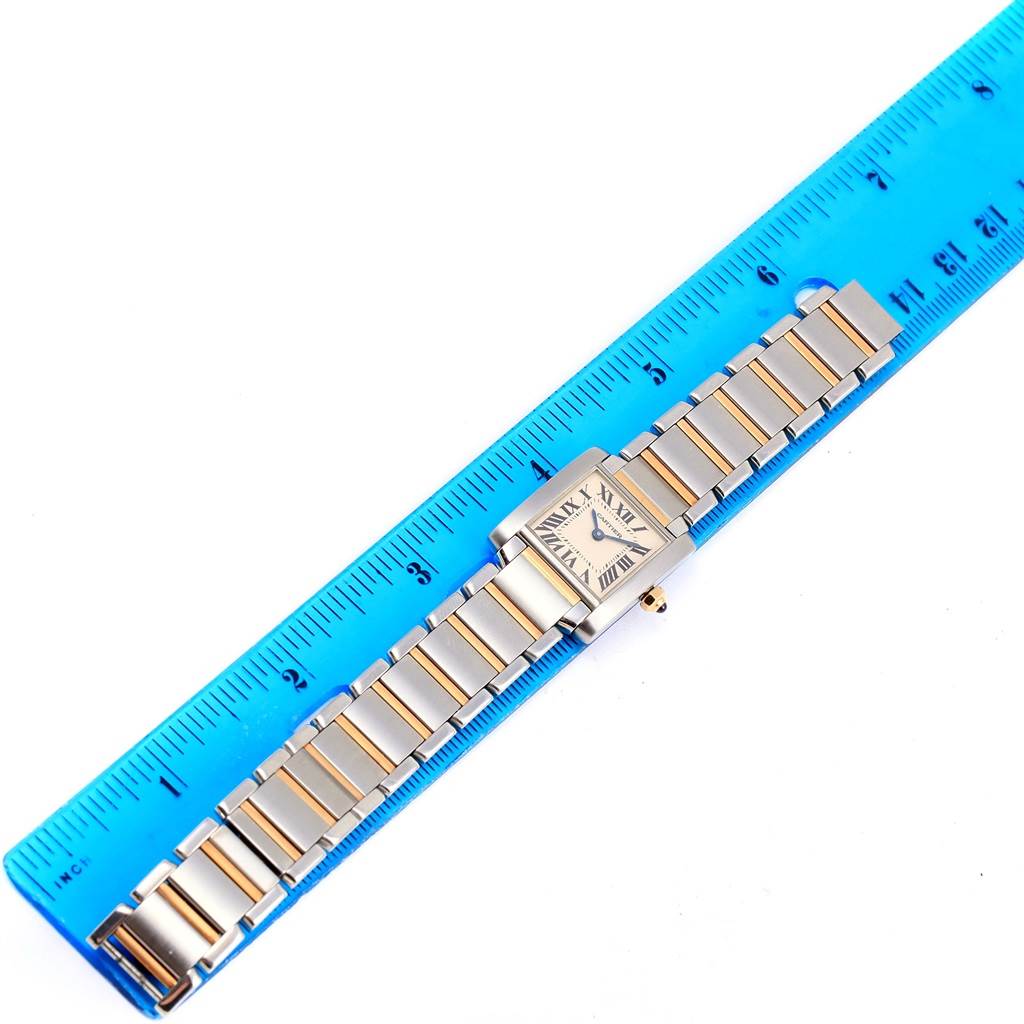 The image shows a top-down view of a Cartier Tank Francaise W51007Q4 Women's Steel and Gold (two tone) Silver Dial W51007Q4 Women's Steel and Gold (two tone) Silver Dial watch, aligned next to a blue ruler.
