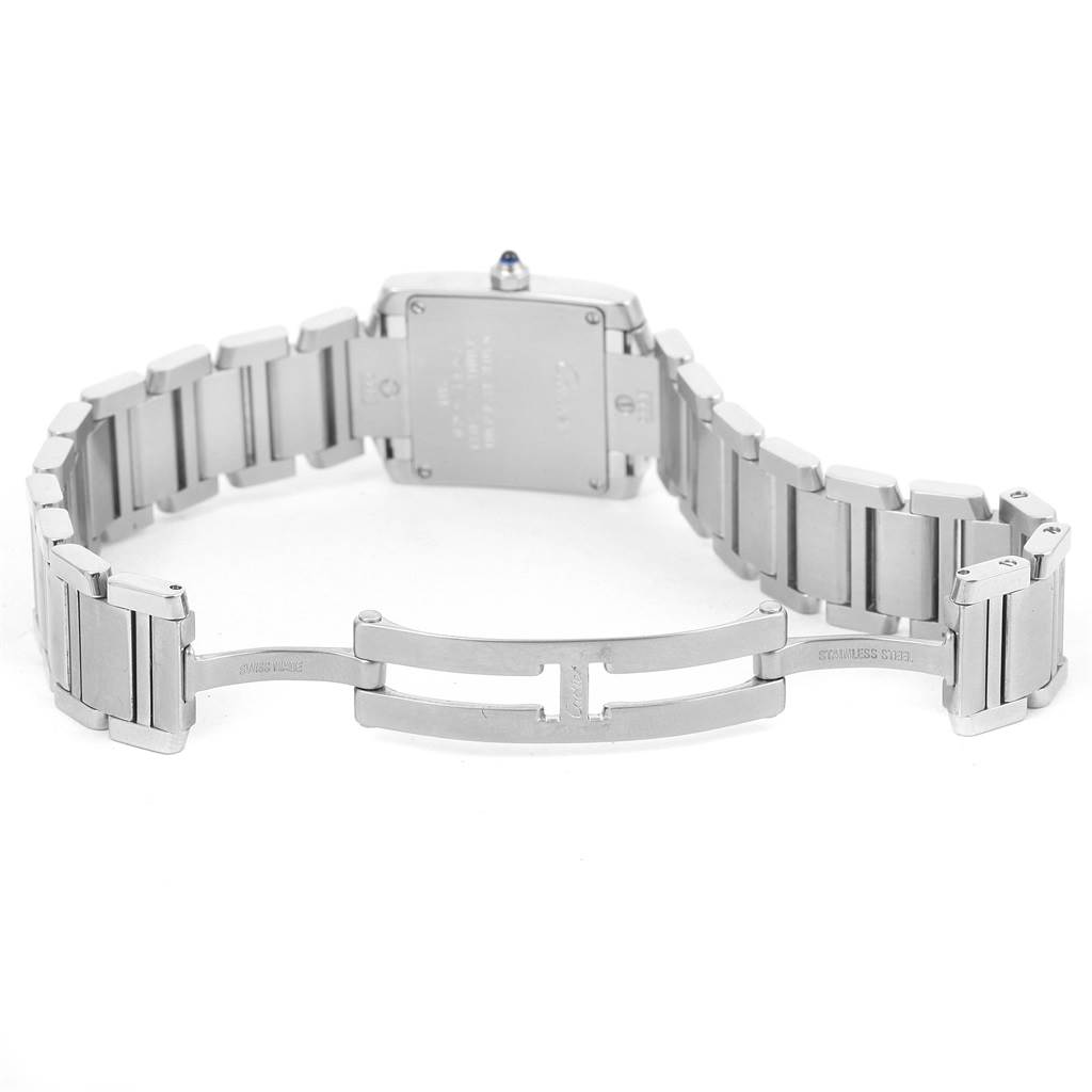The image depicts the back of the Cartier Tank Française watch, including the stainless steel bracelet and open clasp.