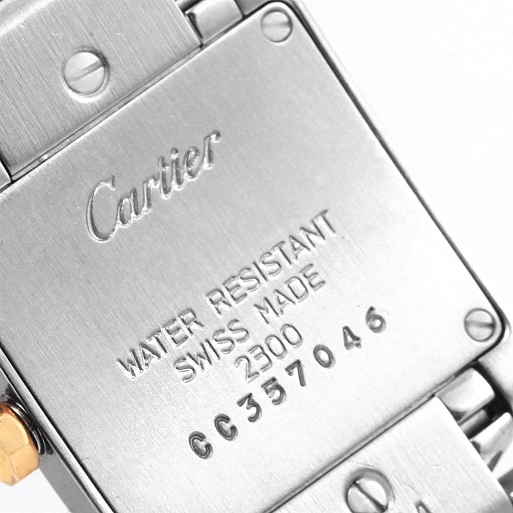 This image shows the back case of a Cartier Tank Francaise W51007Q4 Women's Steel and Gold (two tone) Silver Dial W51007Q4 Women's Steel and Gold (two tone) Silver Dial watch, highlighting its engravings and screws.