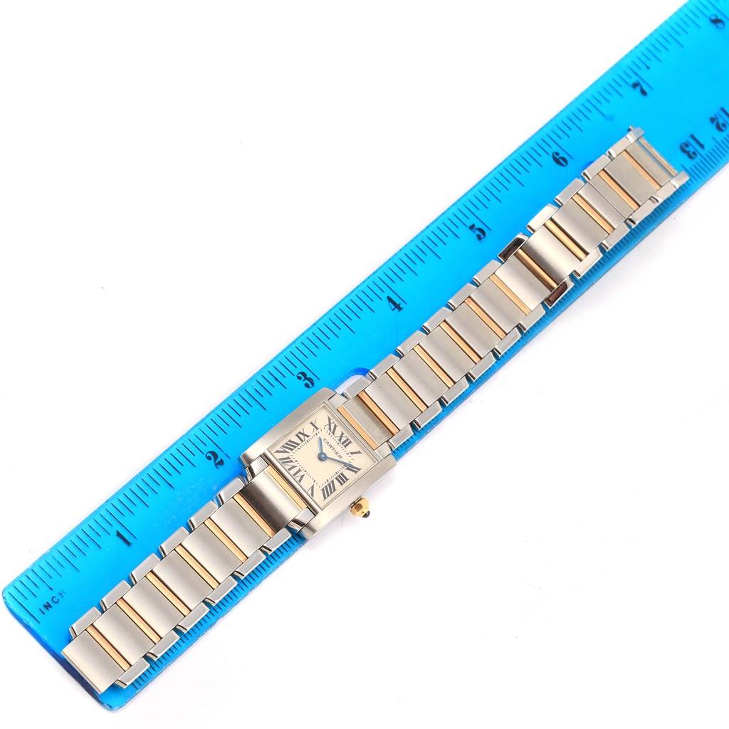 The Cartier Tank Francaise W51007Q4 Women's Steel and Gold (two tone) Silver Dial W51007Q4 Women's Steel and Gold (two tone) Silver Dial watch is shown from a top-down angle with its band placed alongside a ruler.