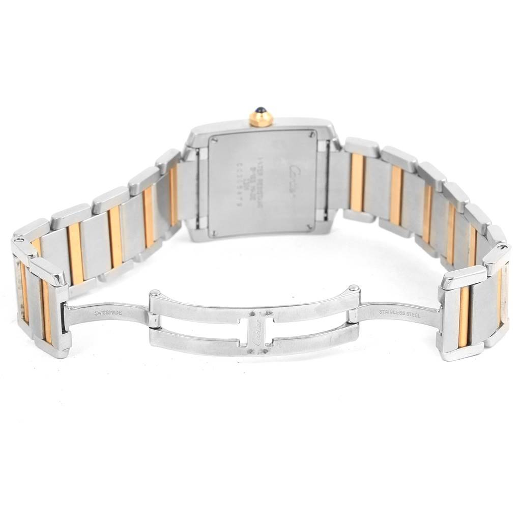The image shows the back and bracelet of a Tank Francaise watch by Cartier, highlighting the two-tone metal bracelet and folding clasp.