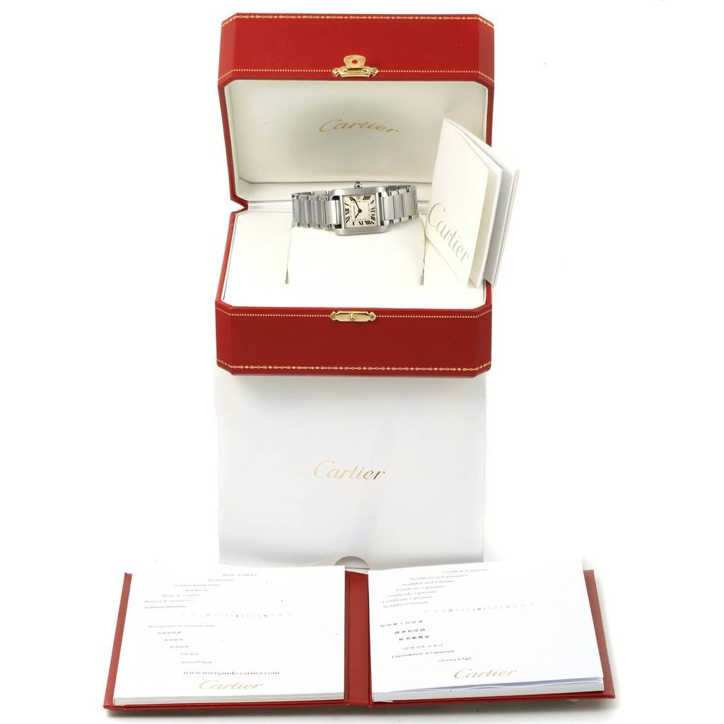 The Tank Francaise Cartier watch is displayed in its box with accompanying documentation and a red exterior packaging.