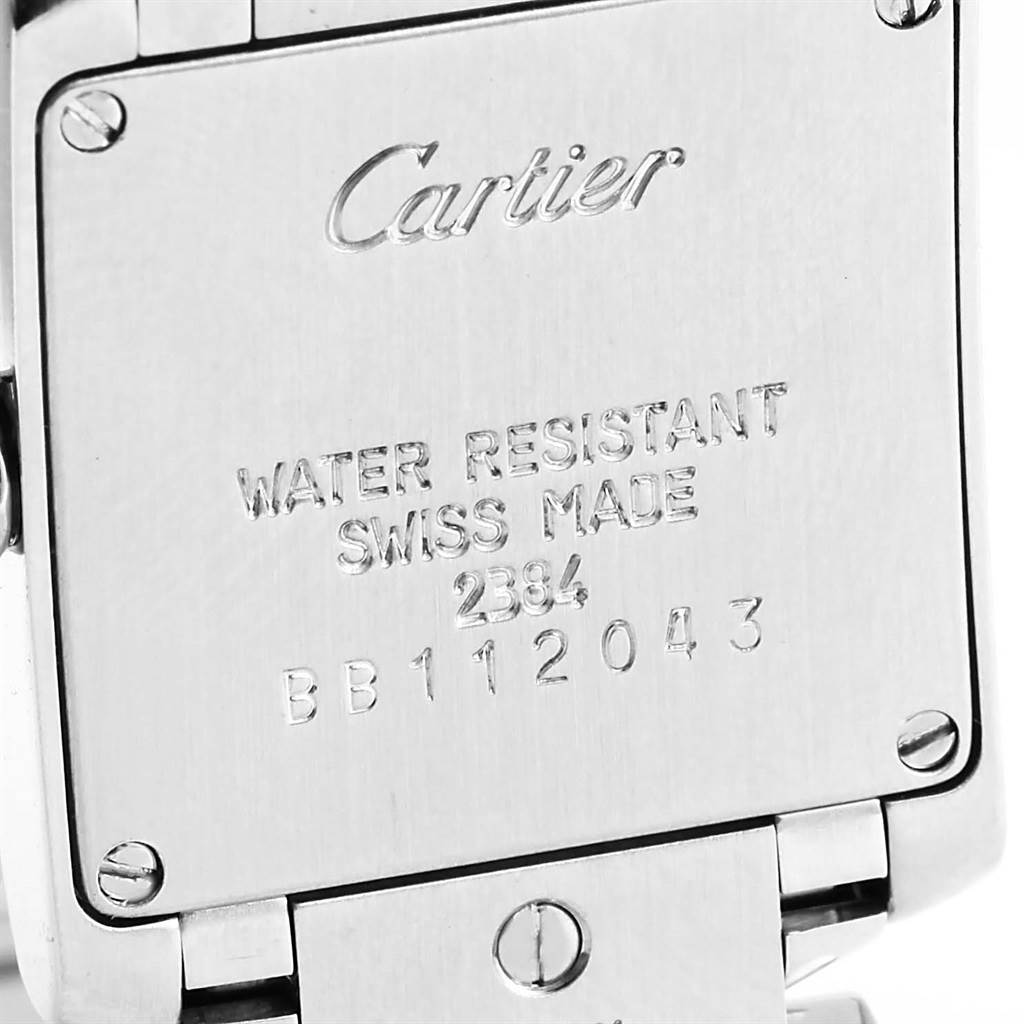 This image shows the back case of the Cartier Tank Francaise W51008Q3 Women's Stainless Steel Silver Dial W51008Q3 Women's Stainless Steel Silver Dial watch with engravings and part of the bracelet.