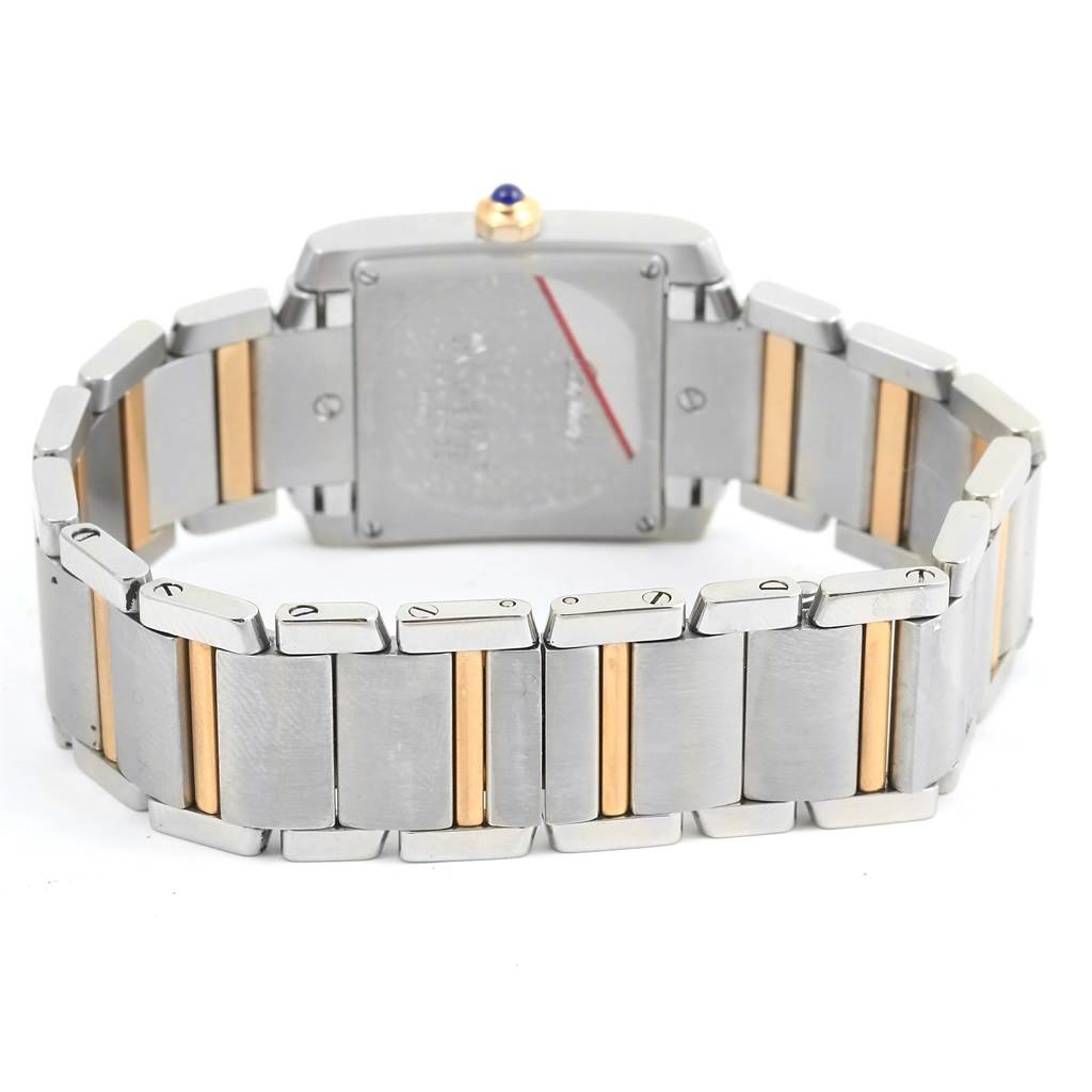 The image shows the back and bracelet of a Cartier Tank Française watch, emphasizing the two-tone metal links.