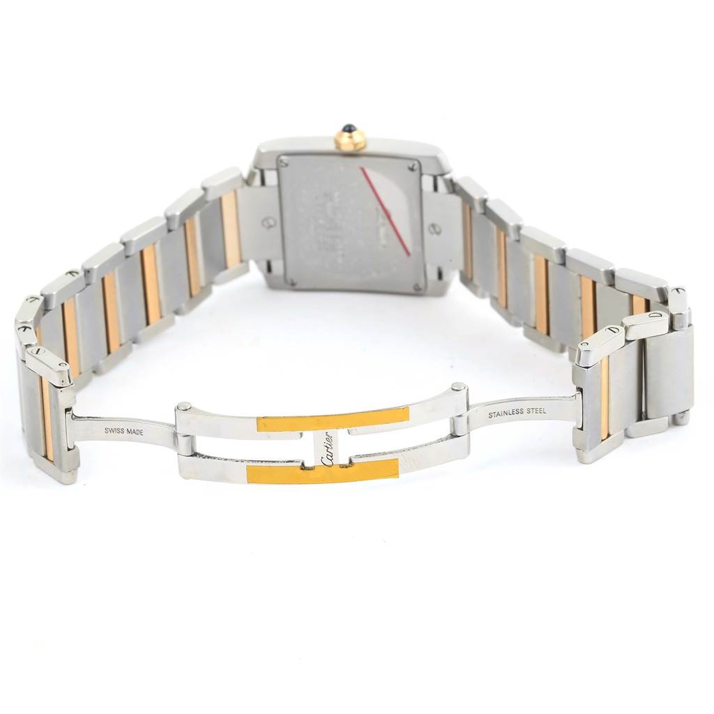 The image shows the back view of a Cartier Tank Francaise W51012Q4 Women's Steel and Gold (two tone) Silver Dial W51012Q4 Women's Steel and Gold (two tone) Silver Dial watch, including the case back and open bracelet clasp.