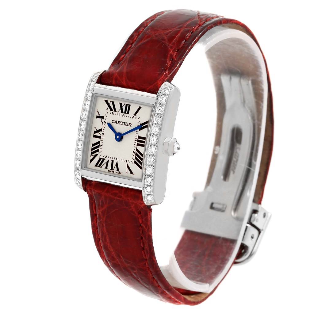 The image shows a Cartier Tank Francaise WE100231 Women's White Gold Silver Dial WE100231 Women's White Gold Silver Dial watch at an angled view, highlighting the red leather strap, diamond-set bezel, and rectangular dial.