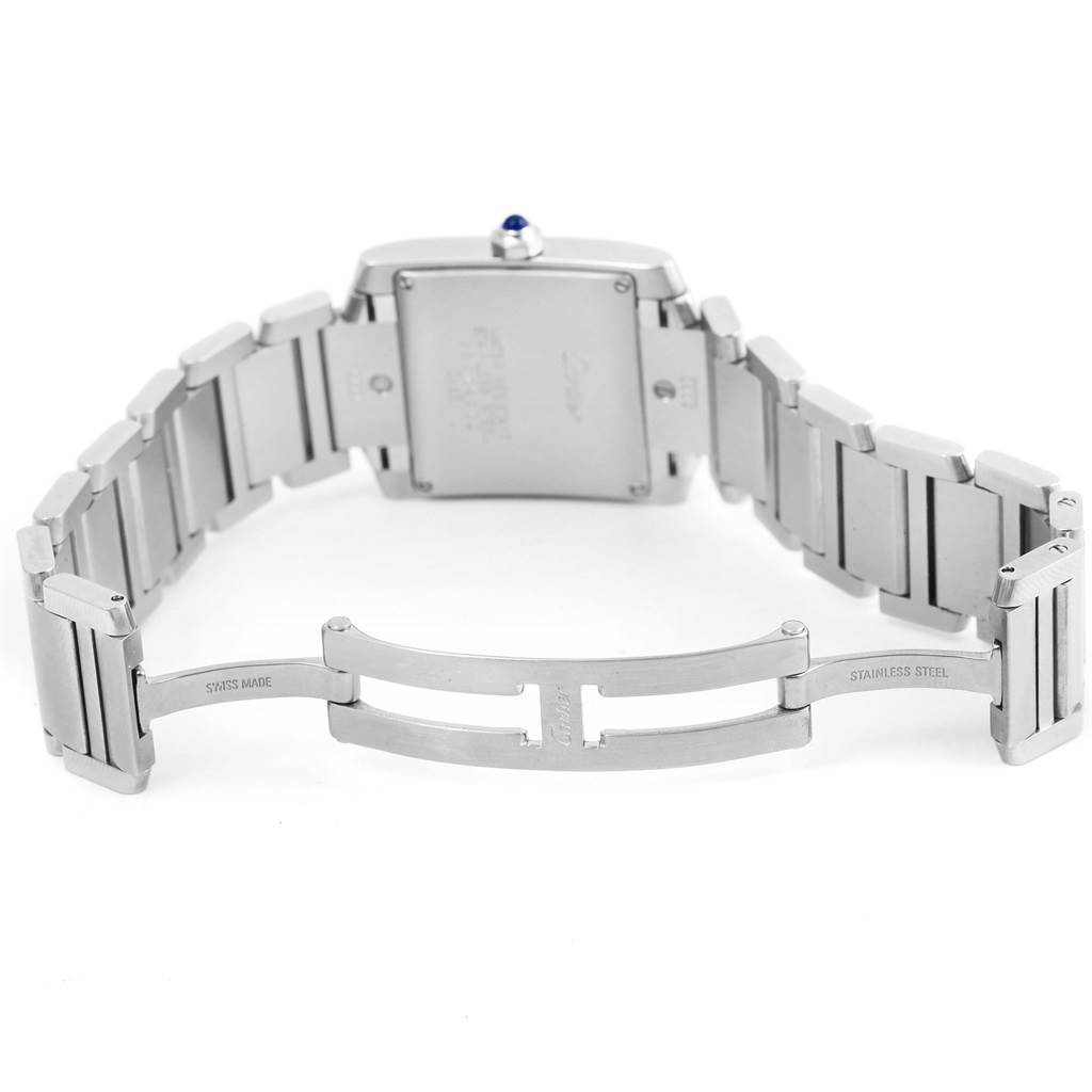 The image shows the back and open stainless steel bracelet clasp of a Cartier Tank Française watch.