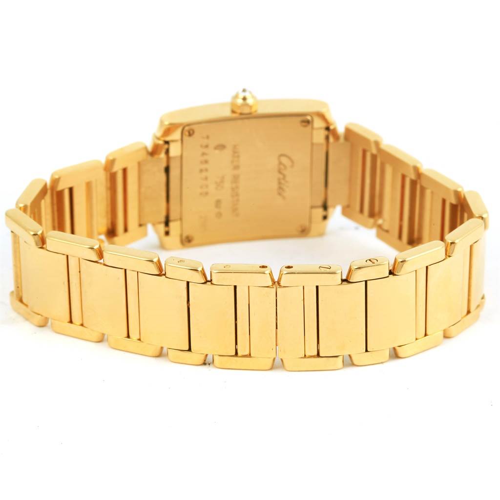 This image shows the back of the Cartier Tank Française watch, featuring its gold bracelet and case back.