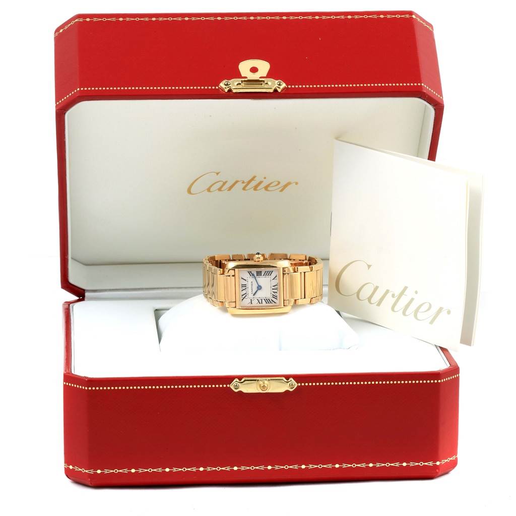 The Cartier Tank Française watch is shown inside a red Cartier box with the manual placed beside it.