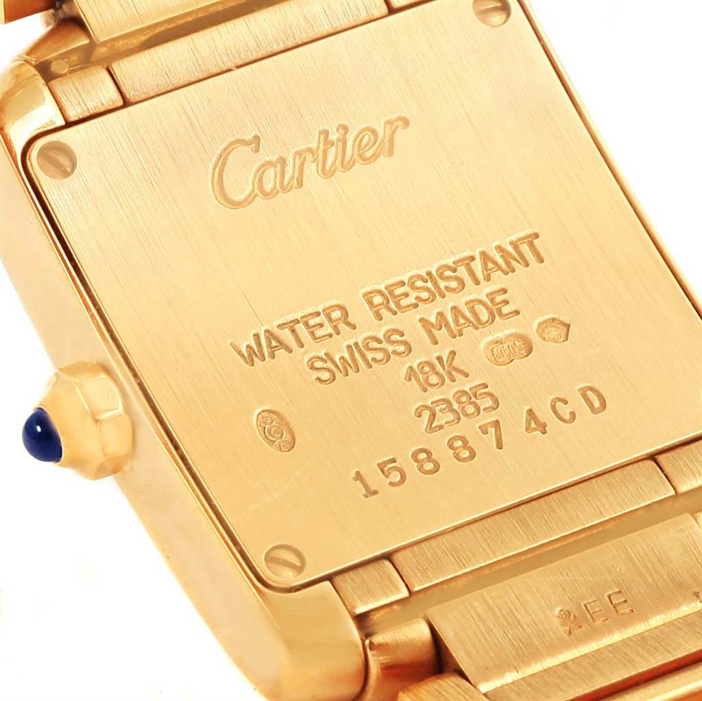 This image shows the back of a Cartier Tank Francaise W50002N2 Women's Yellow Gold Silver Dial W50002N2 Women's Yellow Gold Silver Dial watch, highlighting the inscriptions and logo.
