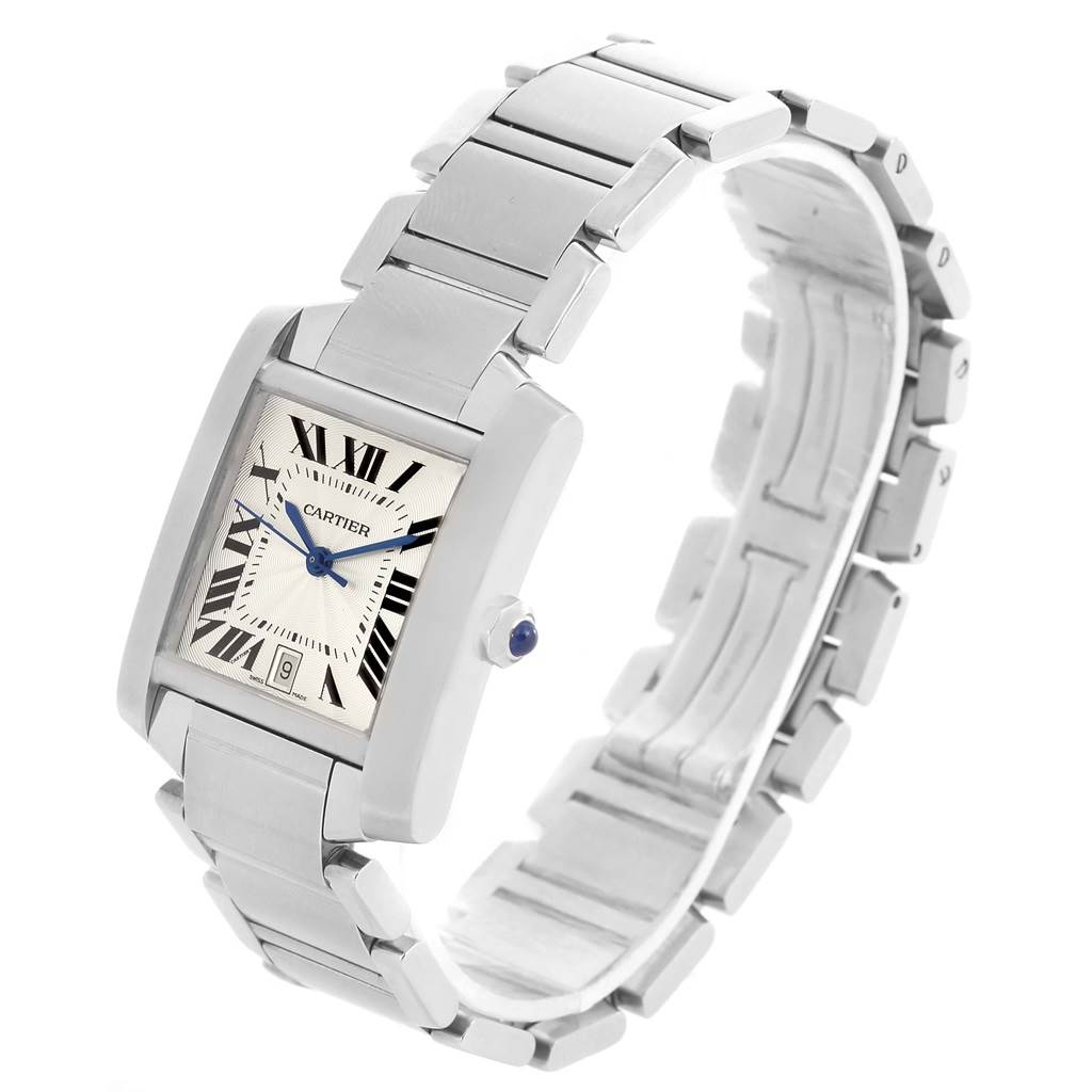 The image shows a Cartier Tank Française watch at a three-quarter angle, highlighting its case, bracelet, and crown with a blue cabochon.
