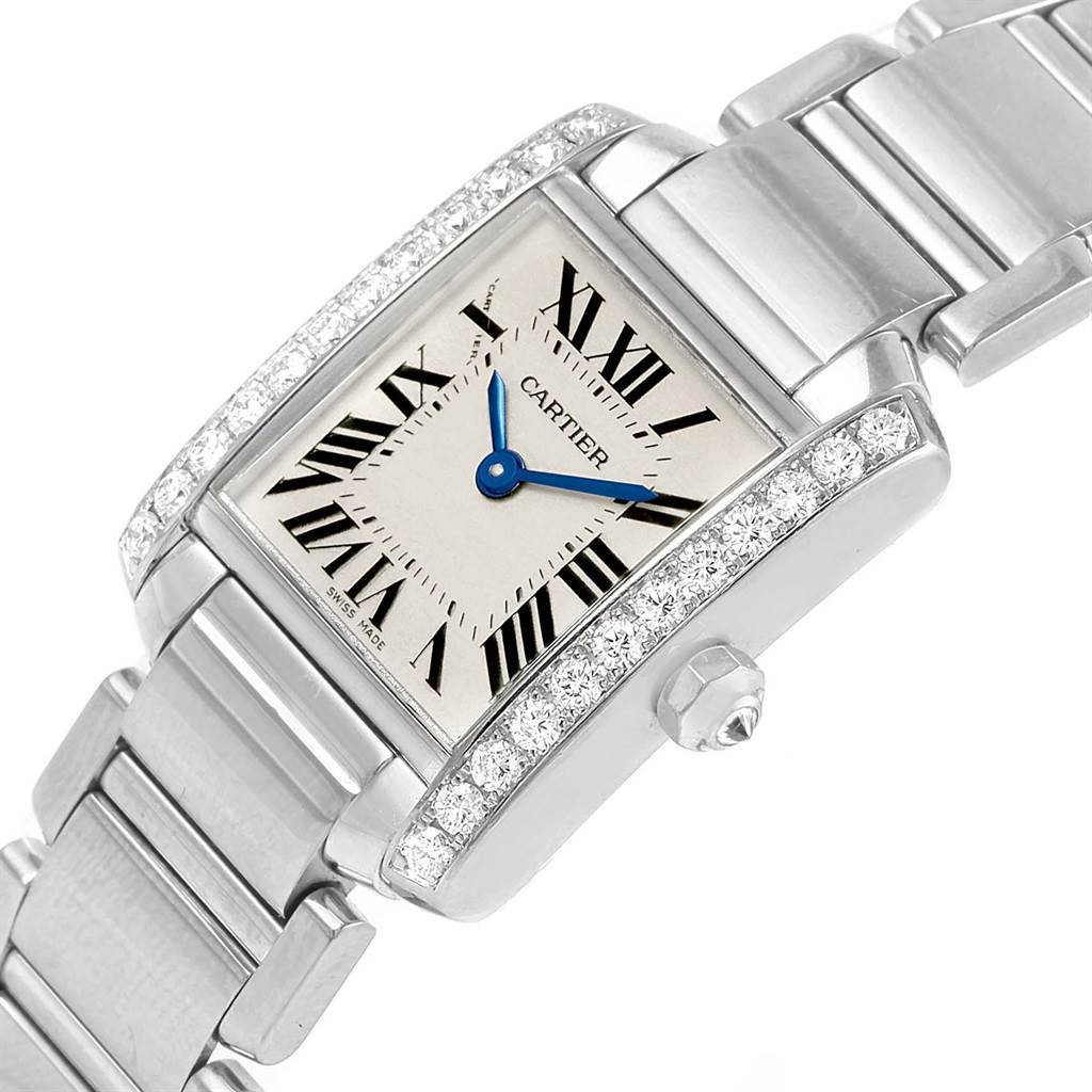 This image shows a Cartier Tank Française watch at an angled close-up, highlighting its dial, bracelet, and diamond-studded bezel.