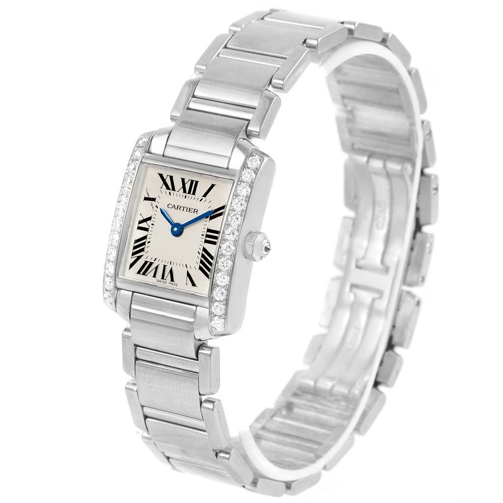 The image shows a Cartier Tank Francaise WE1002S3 Women's White Gold Silver Dial WE1002S3 Women's White Gold Silver Dial watch at an angled view, highlighting the face, bracelet, and diamond-studded bezel.
