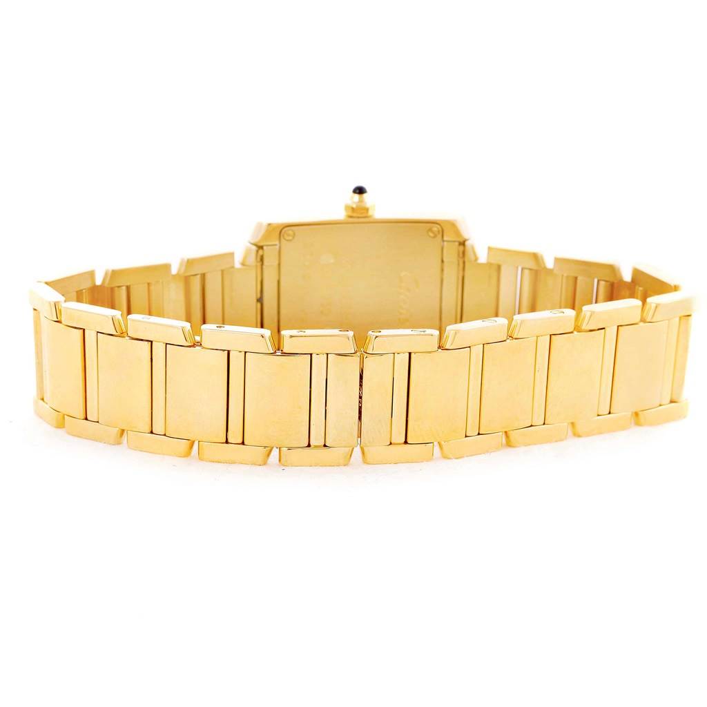 The image shows the Cartier Tank Francaise W50002N2 Women's Yellow Gold Silver Dial W50002N2 Women's Yellow Gold Silver Dial watch from the back, highlighting its gold bracelet and case.