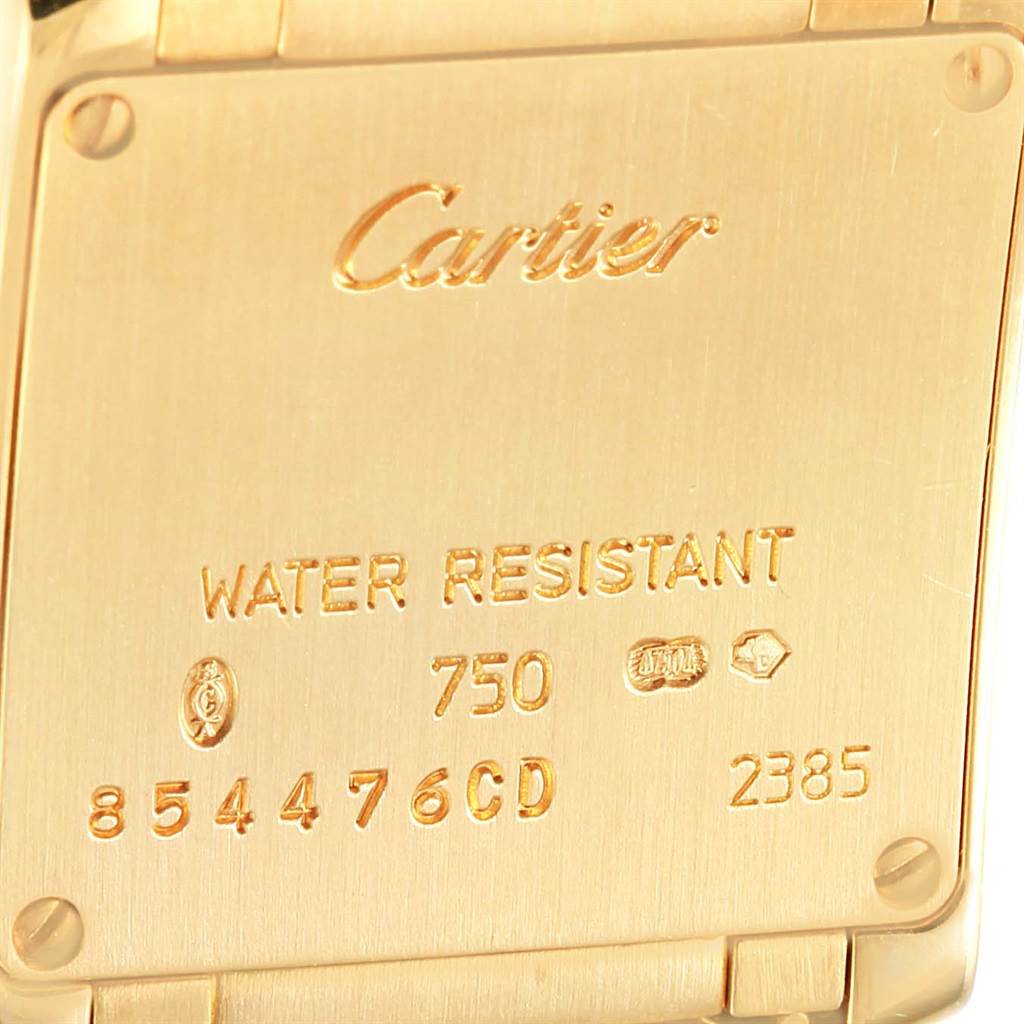 The image shows the back case of a Cartier Tank Francaise W50002N2 Women's Yellow Gold Silver Dial W50002N2 Women's Yellow Gold Silver Dial watch, featuring engravings and hallmarks.
