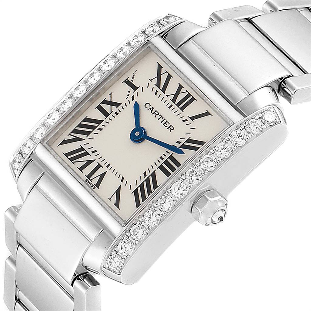 The image shows a Cartier Tank Francaise WE1002S3 Women's White Gold Silver Dial WE1002S3 Women's White Gold Silver Dial watch at a slanted angle, highlighting its diamond-set bezel and bracelet.