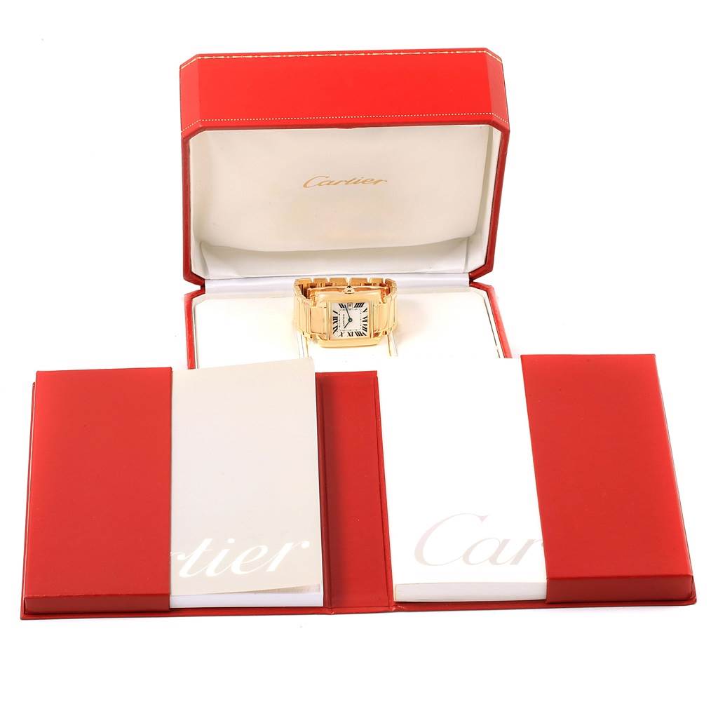 The image shows a Cartier Tank Française watch in a red box, with manuals beside it.