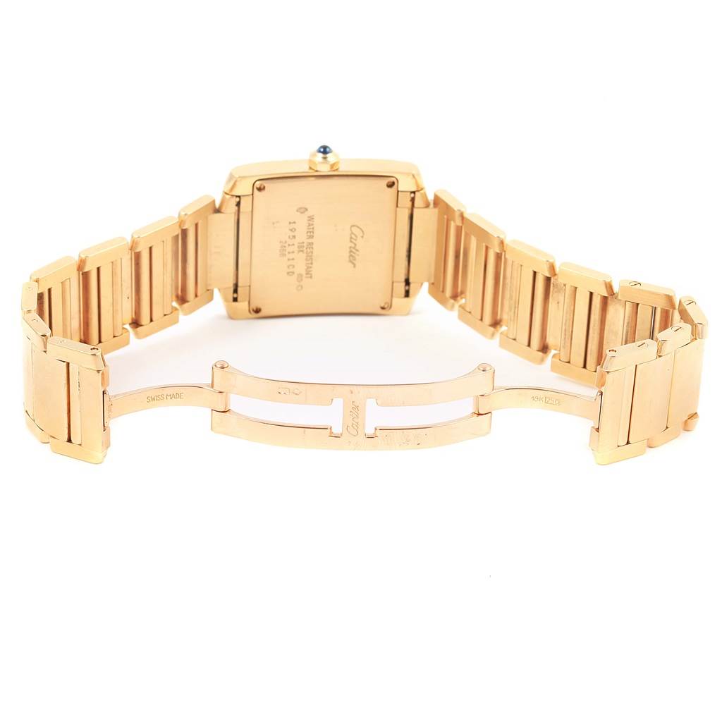 The image shows the back and the open clasp of the Cartier Tank Francaise W50014N2 Women's Yellow Gold Silver Dial W50014N2 Women's Yellow Gold Silver Dial watch, highlighting its gold-toned bracelet.