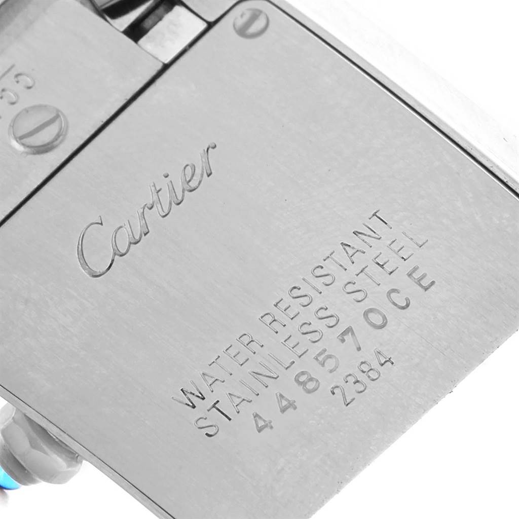 This close-up image shows the back case of a Tank Française watch by Cartier, highlighting the engravings and water resistance specification.